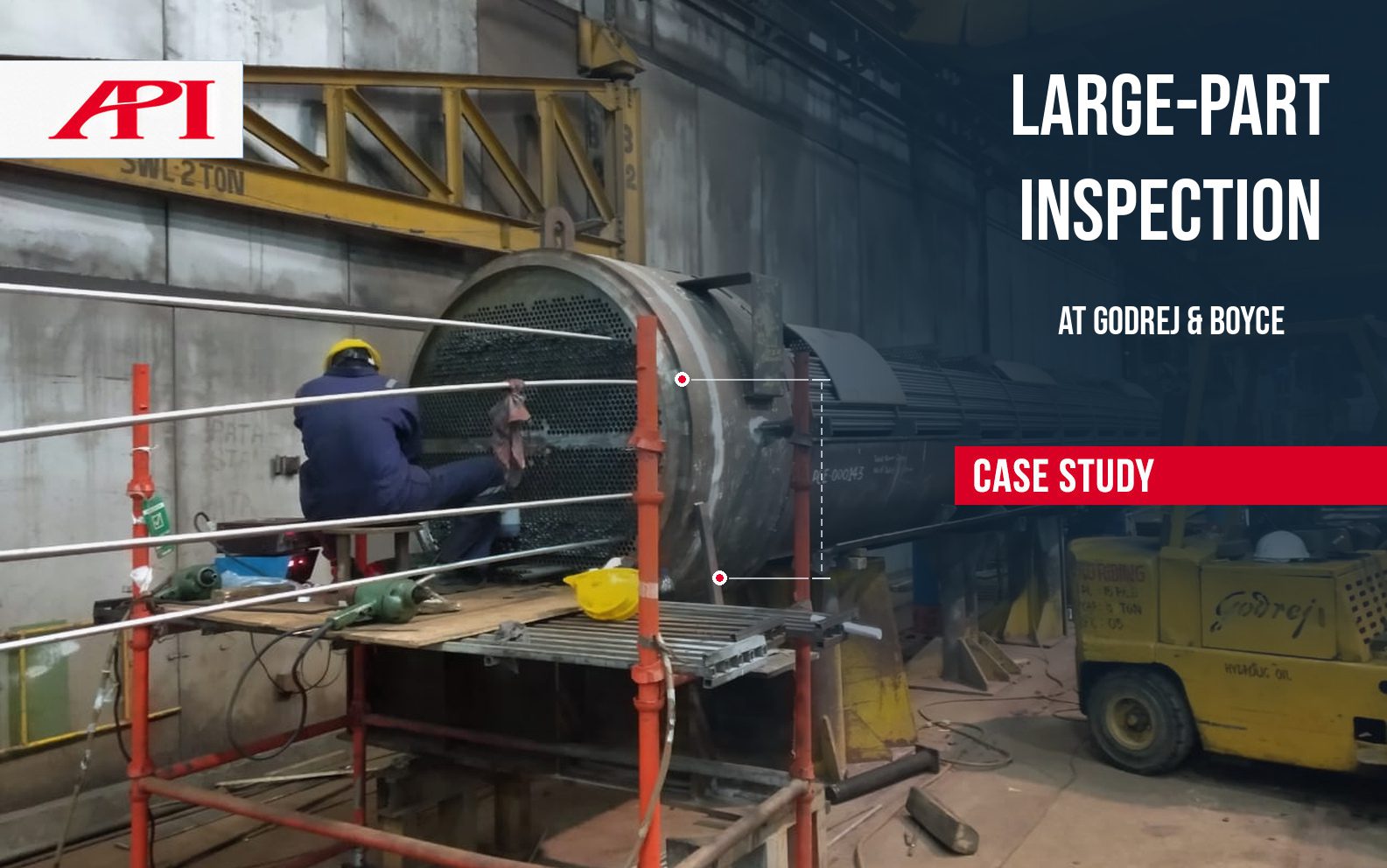 Godrej & Boyce Large-Part Inspection Case Study Worker inspecting a large feedwater heater at Godrej & Boyce, with API large-part inspection case study branding.